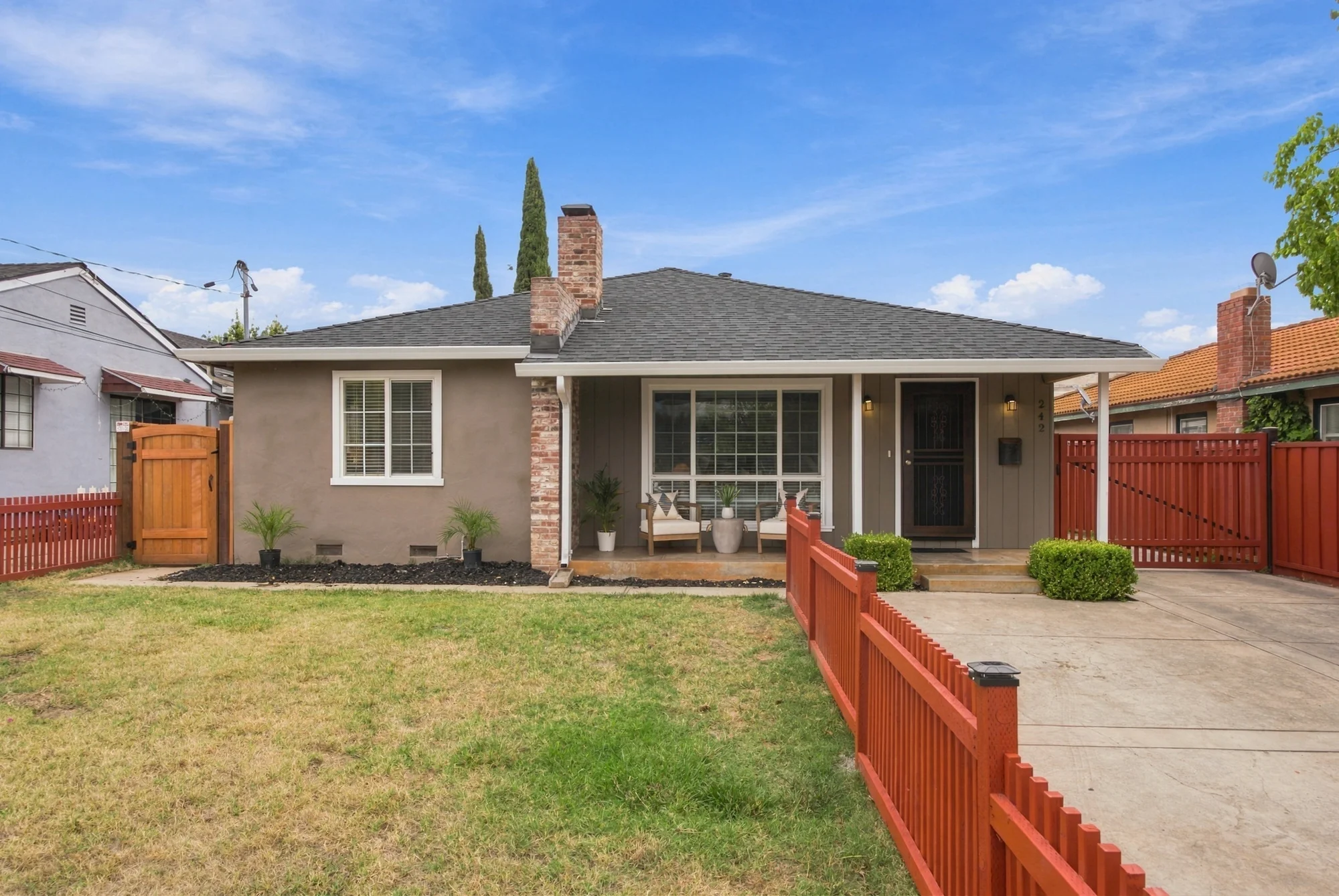 Front exterior of 242 Laumer Avenue with a covered porch and lawn