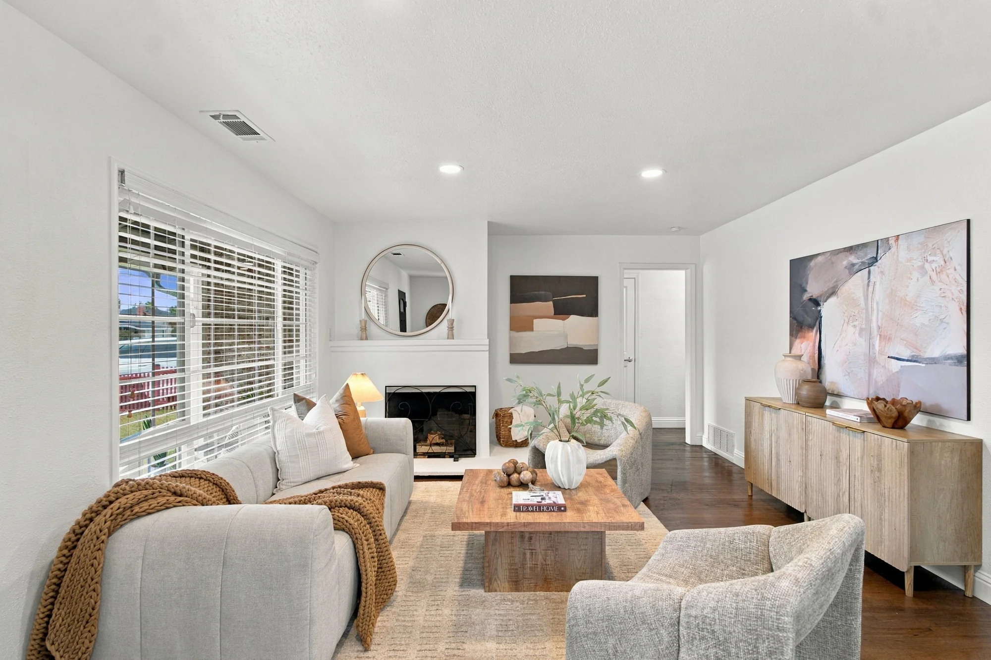 Bright front living room with hardwood floors and large windows